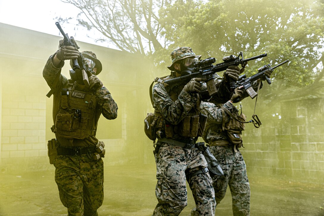 U.S. Marines maneuver through smoke during Exercise Samurai 23-3 on Okinawa, Japan, July 27, 2023. The exercise allowed the Marines to maintain tactical proficiency and lethality. The Marines are with Headquarters Battalion, 3d Marine Division. (U.S. Marine Corps photo by Cpl. Israel Sheber)