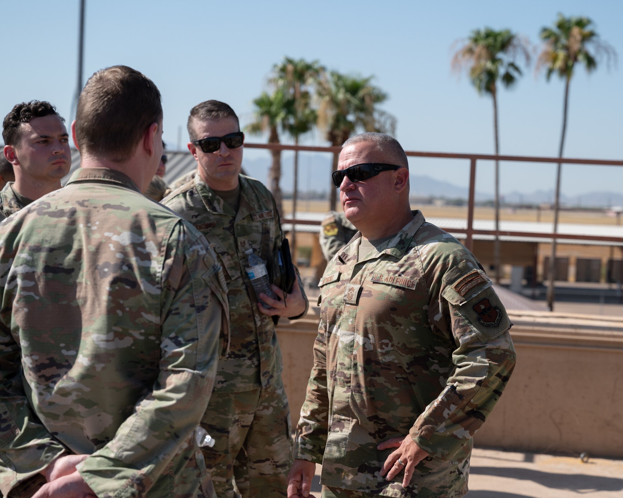 U.S. Air Force Chief Master Sgt. Justin Apticar, Nineteenth Air Force command chief, engages with Airmen Aug. 1, 2023, at Luke Air Force Base, Arizona.