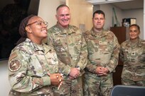 192nd Wing members standing in front of conference room.