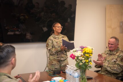 Airman speaking in conference room.