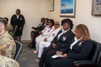 Kappa Epsilon Psi Military Sorority, Inc. members sitting in conference room.