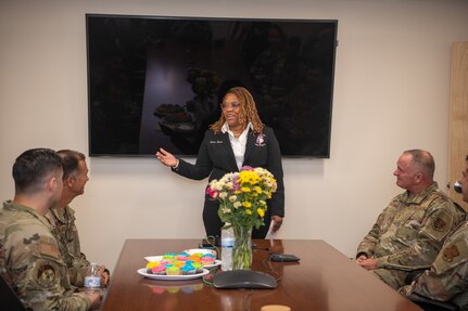 Member of Kappa Epsilon Psi Military Sorority, Inc. speaking in conference room.