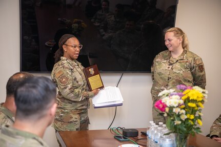 Airman presenting plaque.