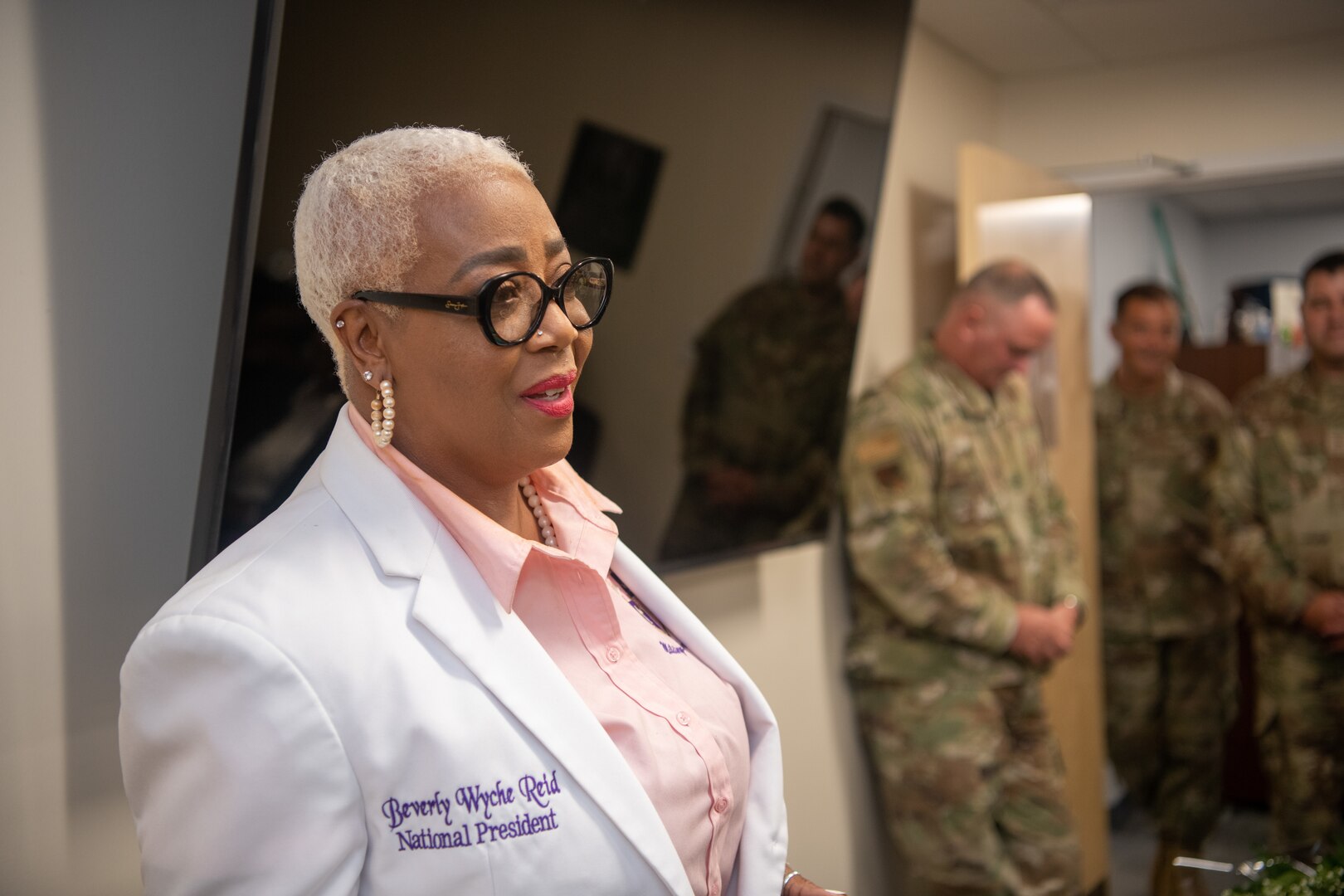 Kappa Epsilon Psi Military Sorority's National President talks in conference room.