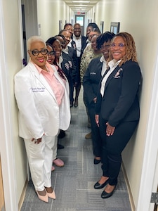 Members of Kappa Epsilon Psi Military Sorority, Inc. stands in hallway.