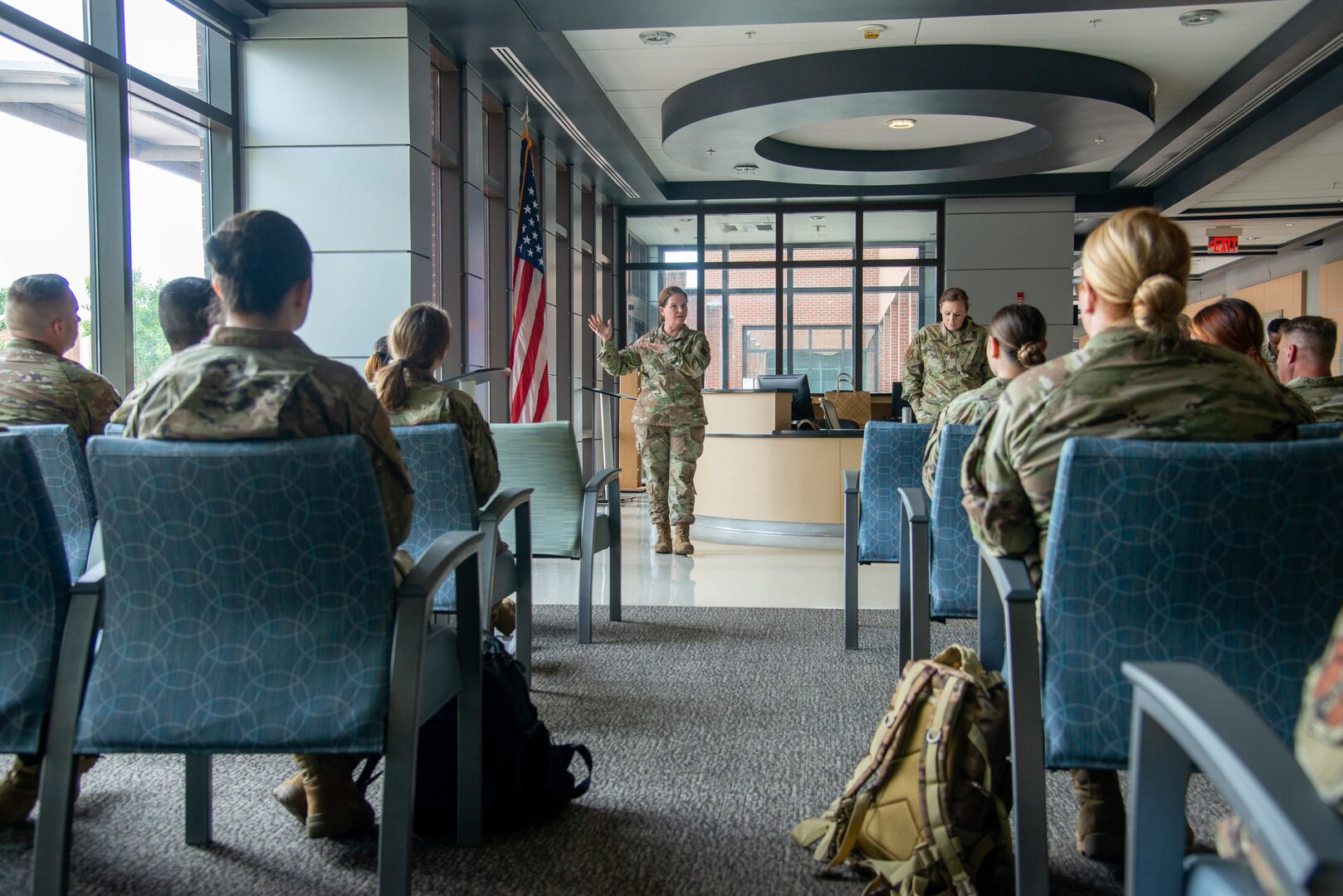 Col. Linda Rohatsch speaks in front of a group of Airmen.