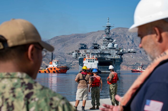 Sailors assigned to Naval Support Activity Souda Bay standby to moor the Wasp-class amphibious assault ship USS Bataan (LHD 5) at the NATO Marathi Pier Complex on Aug. 2, 2023.  NSA Souda Bay provided fuel and personnel support services to USS Bataan while in port.