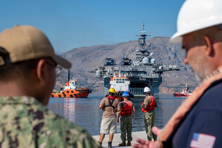 Sailors assigned to Naval Support Activity Souda Bay standby to moor the Wasp-class amphibious assault ship USS Bataan (LHD 5) at the NATO Marathi Pier Complex on Aug. 2, 2023.  NSA Souda Bay provided fuel and personnel support services to USS Bataan while in port.
