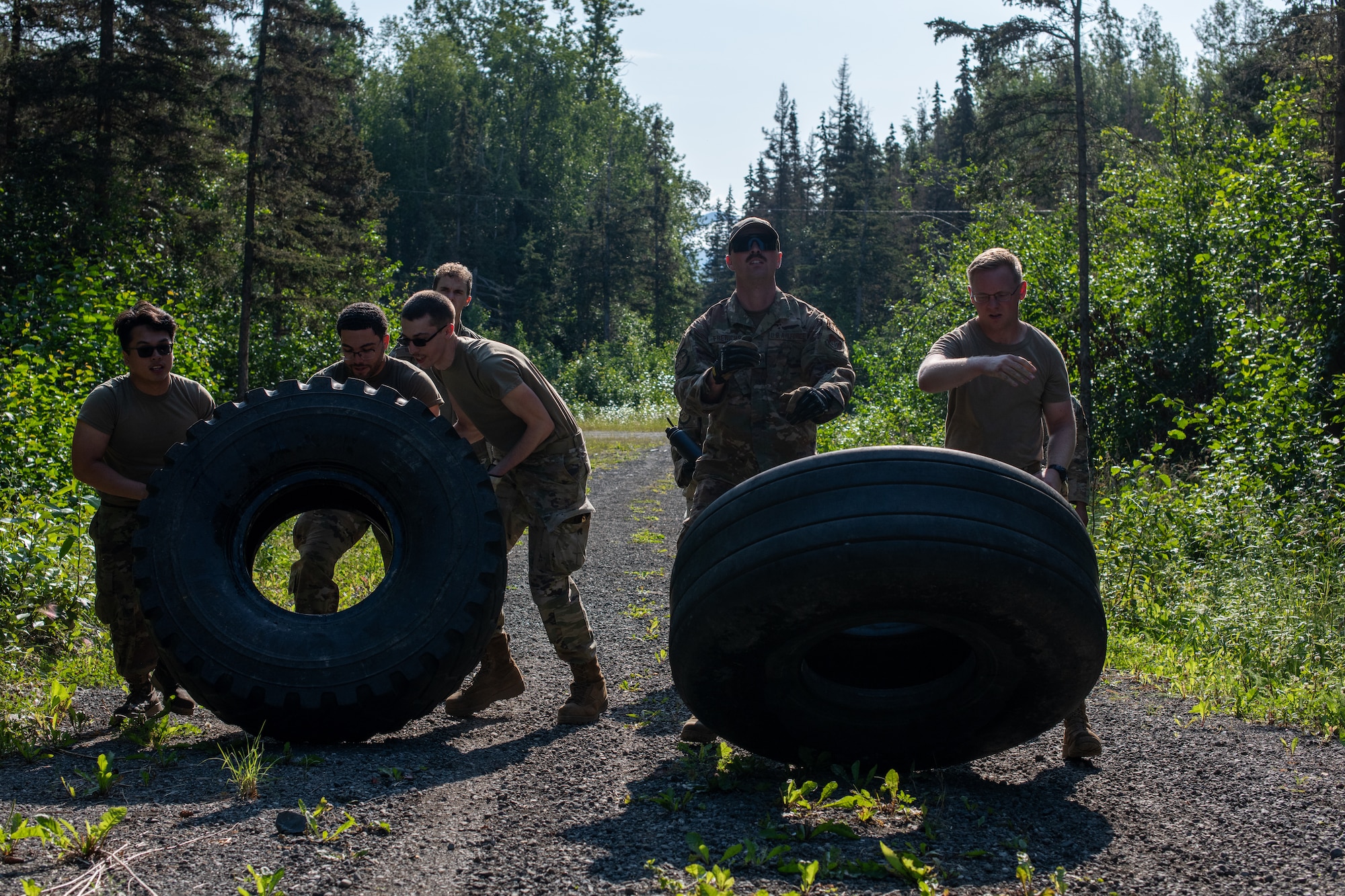 A photo of Airmen flipping two tires