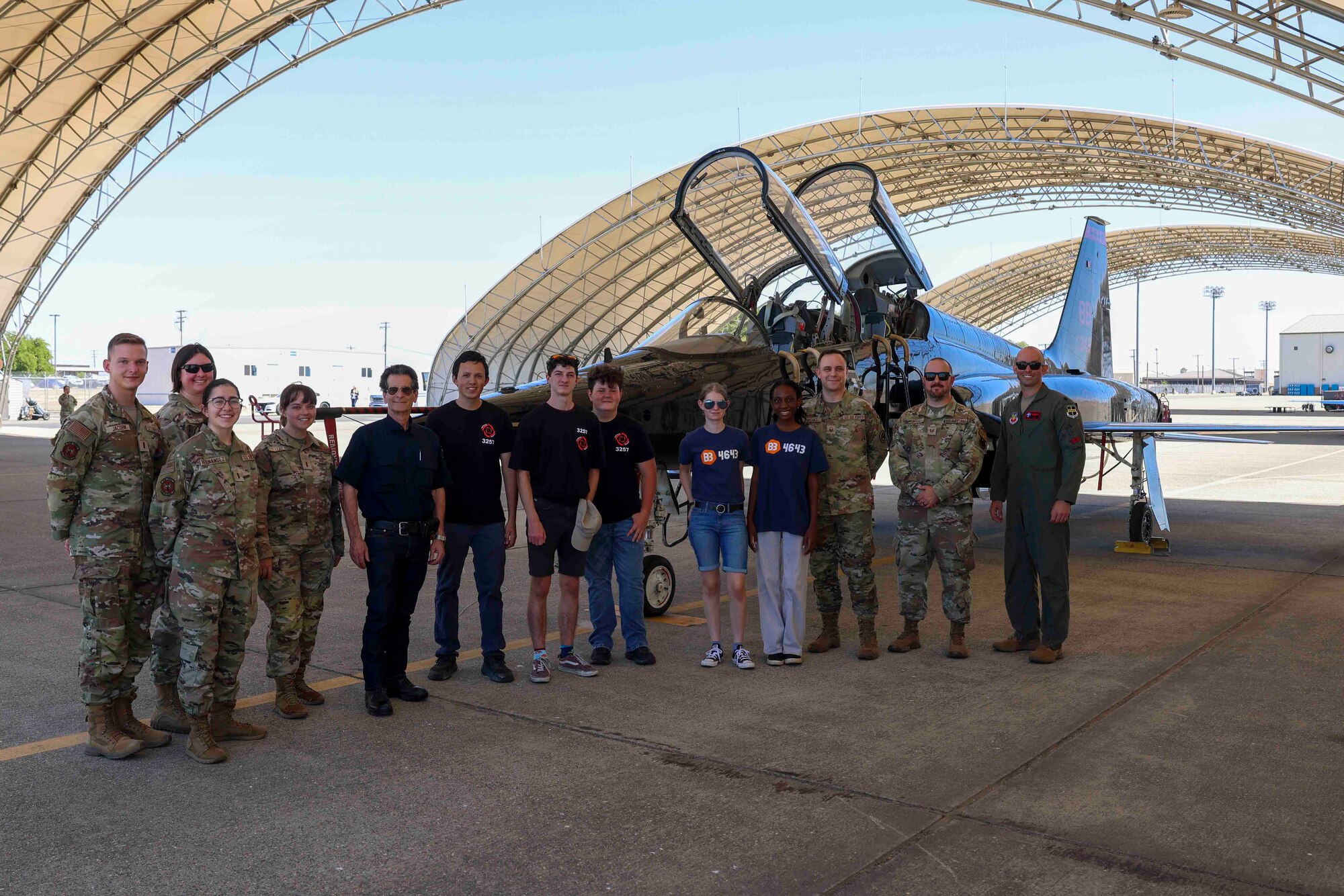 Members of the Air Force Recruiting Service, and Beale members pose for a group photo in front of a T-38 Talon with students from For Inspiration and Recognition of Science and Technology (FIRST), and its founder Dean Kamen, Aug. 3, 2023, at Beale Air Force Base, California.
