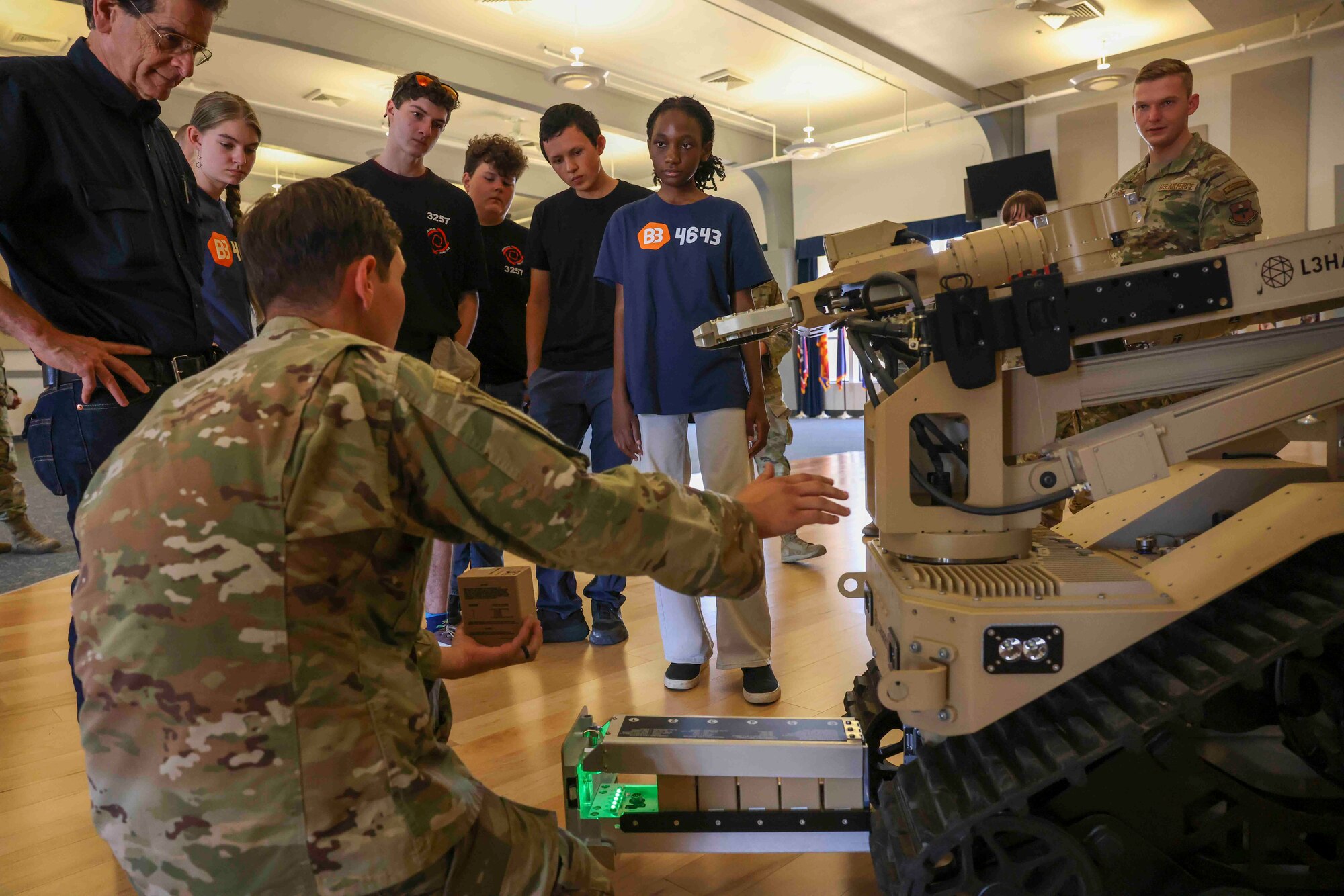 U.S. Air Force Staff Sgt. Hunter Rudnik, 9th Civil Engineer Squadron explosive ordnance technician, demonstrates the T-7 Explosive Ordnance Disposal robot to students with For Inspiration and Recognition of Science and Technology (FIRST), and its founder Dean Kamen during a base tour Aug. 3, 2023, at Beale Air Force Base, California.