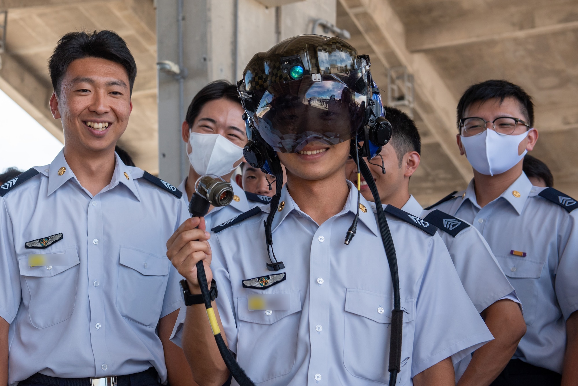 A Japan Air Self-Defense Force cadet tries on an F-35A Lightning II helmet