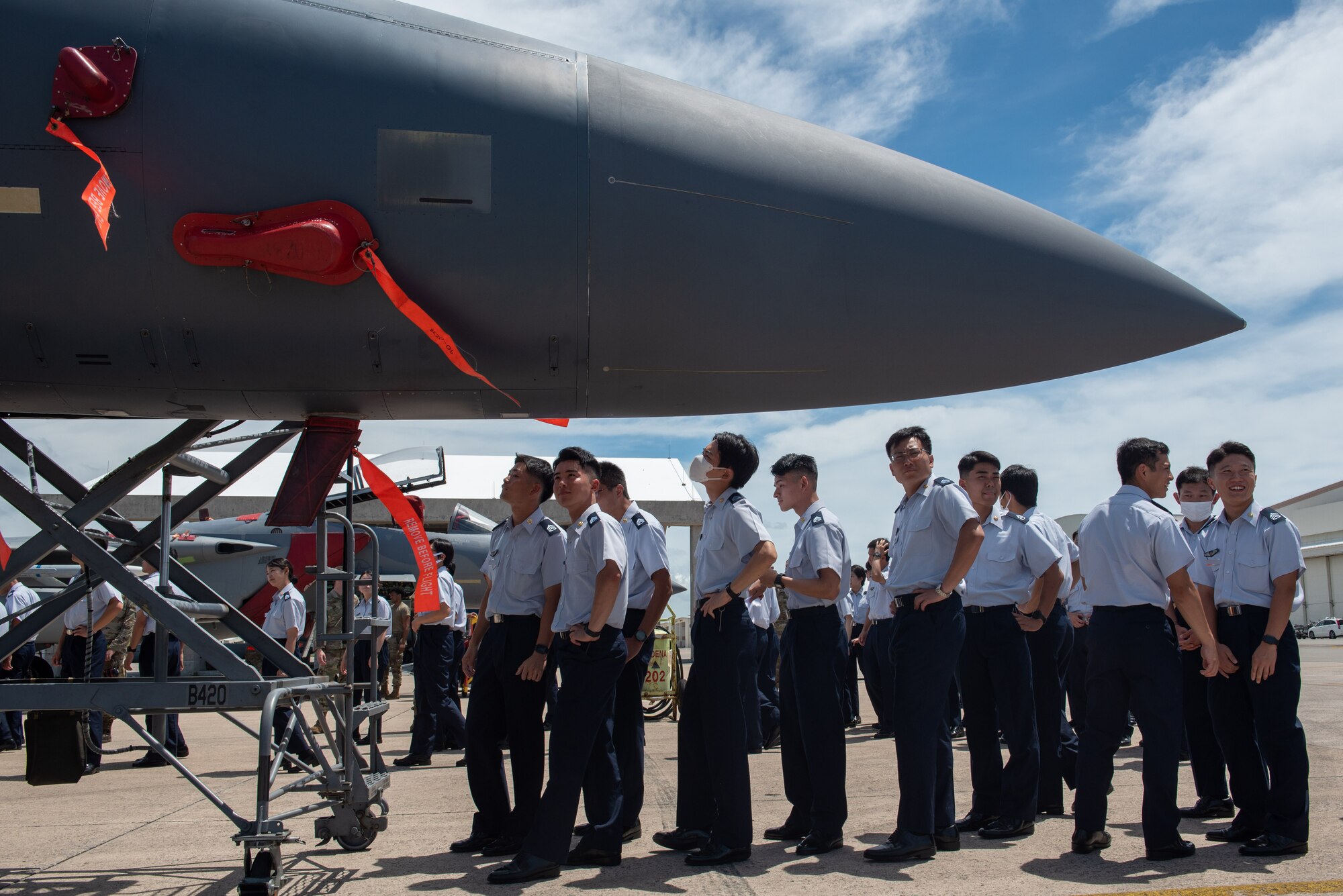 Japan Air Self-Defense Force cadets line-up to see the cockpit of an F-15E Strike Eagle