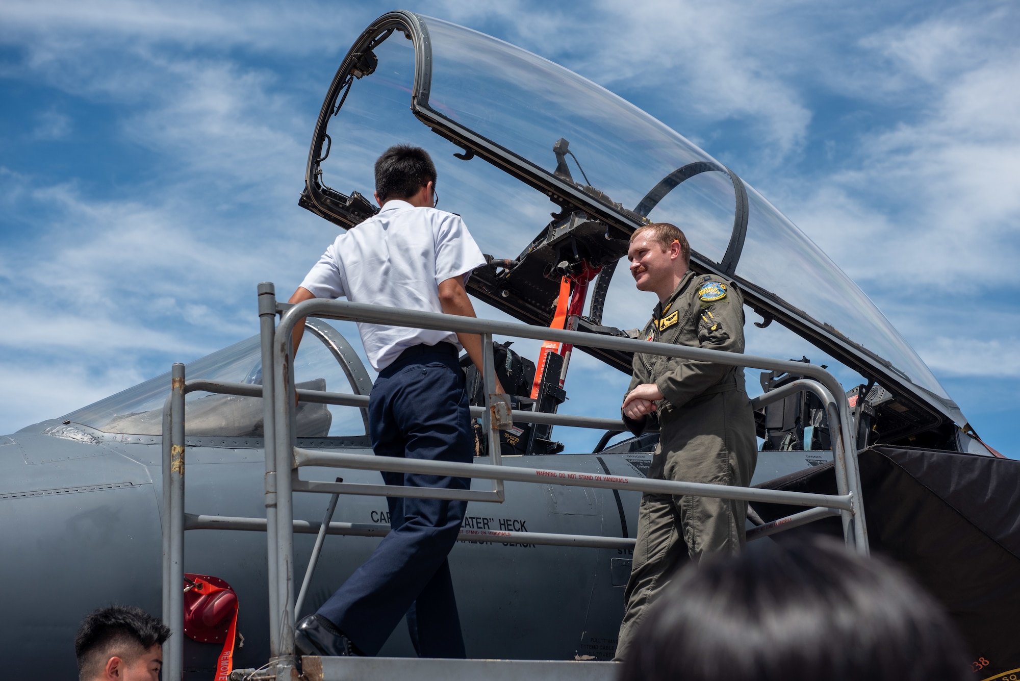 A Japan Air Self-Defense Force cadet speaks to a U.S. Air Force pilot