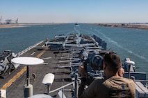 230806-M-NF490-1029 SUEZ CANAL (Aug. 6, 2023) A U.S. Navy sailor from USS Bataan (LHD 5) stands watch as the amphibious assault ship transits the Suez Canal with the 26th Marine Expeditionary Unit (MEU), Aug. 6, 2023. Components of the Bataan Amphibious Ready Group and 26th MEU are deployed to the U.S. 5th Fleet area of operations to help ensure maritime security and stability in the Middle East region. (U.S. Marine Corps photo by Cpl. Nayelly Nieves-Nieves)