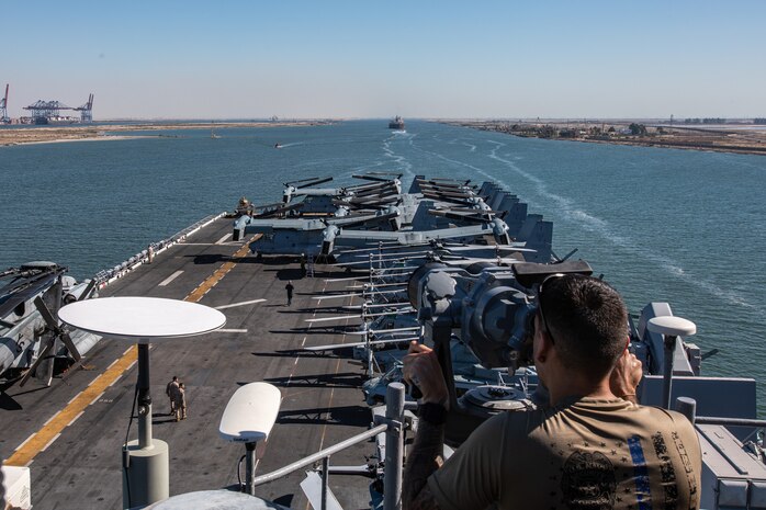 230806-M-NF490-1029 SUEZ CANAL (Aug. 6, 2023) A U.S. Navy sailor from USS Bataan (LHD 5) stands watch as the amphibious assault ship transits the Suez Canal with the 26th Marine Expeditionary Unit (MEU), Aug. 6, 2023. Components of the Bataan Amphibious Ready Group and 26th MEU are deployed to the U.S. 5th Fleet area of operations to help ensure maritime security and stability in the Middle East region. (U.S. Marine Corps photo by Cpl. Nayelly Nieves-Nieves)