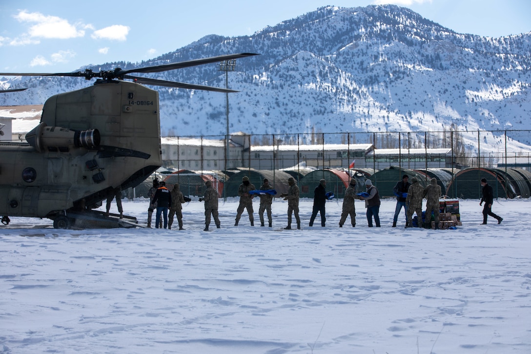 U.S. Army CH-47F Chinook assigned to 3rd Battalion, 501st Aviation Regiment, Combat Aviation Brigade, 1st Armored Division (1AD CAB), delivers relief supplies to AFAD, the Turkish relief authority, in Göksun, Türkiye, Feb. 16, 2023. The 1AD CAB provides dynamic lift capability in direct support of USAID and Turkish relief efforts, to those affected by the earthquakes in Türkiye. 1AD CAB is one of several U.S. military units supporting Task Force 61/2 (TF 61/2), operating under U.S. Sixth Fleet, U.S. Naval Forces Europe (NAVEUR), and U.S. European Command as part of the International Turkish disaster relief efforts. (U.S. Army photo by Spc. William Thompson)