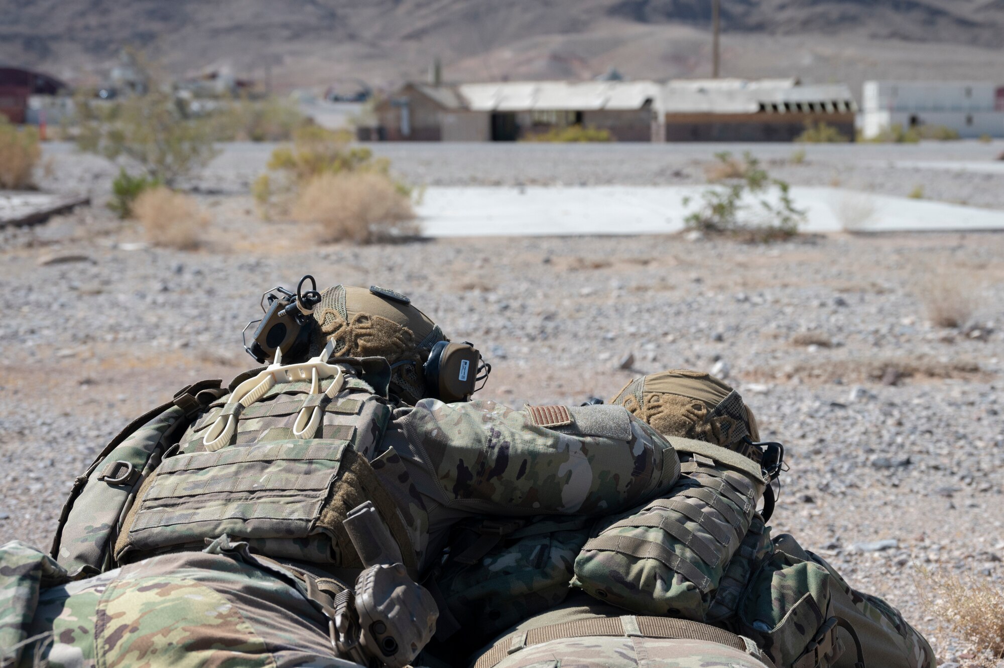 Two U.S. Airmen man a defensive fighting position during an air base defense rehearsal during exercise Red Flag 23-3 at Nellis AFB, Nevada, July 20, 2023. These defenders were establishing security for the forward operating site and contingency locations necessary to perform Agile Combat Employment. (U.S. Air Force photo by Master Sgt. Niles Bartram)