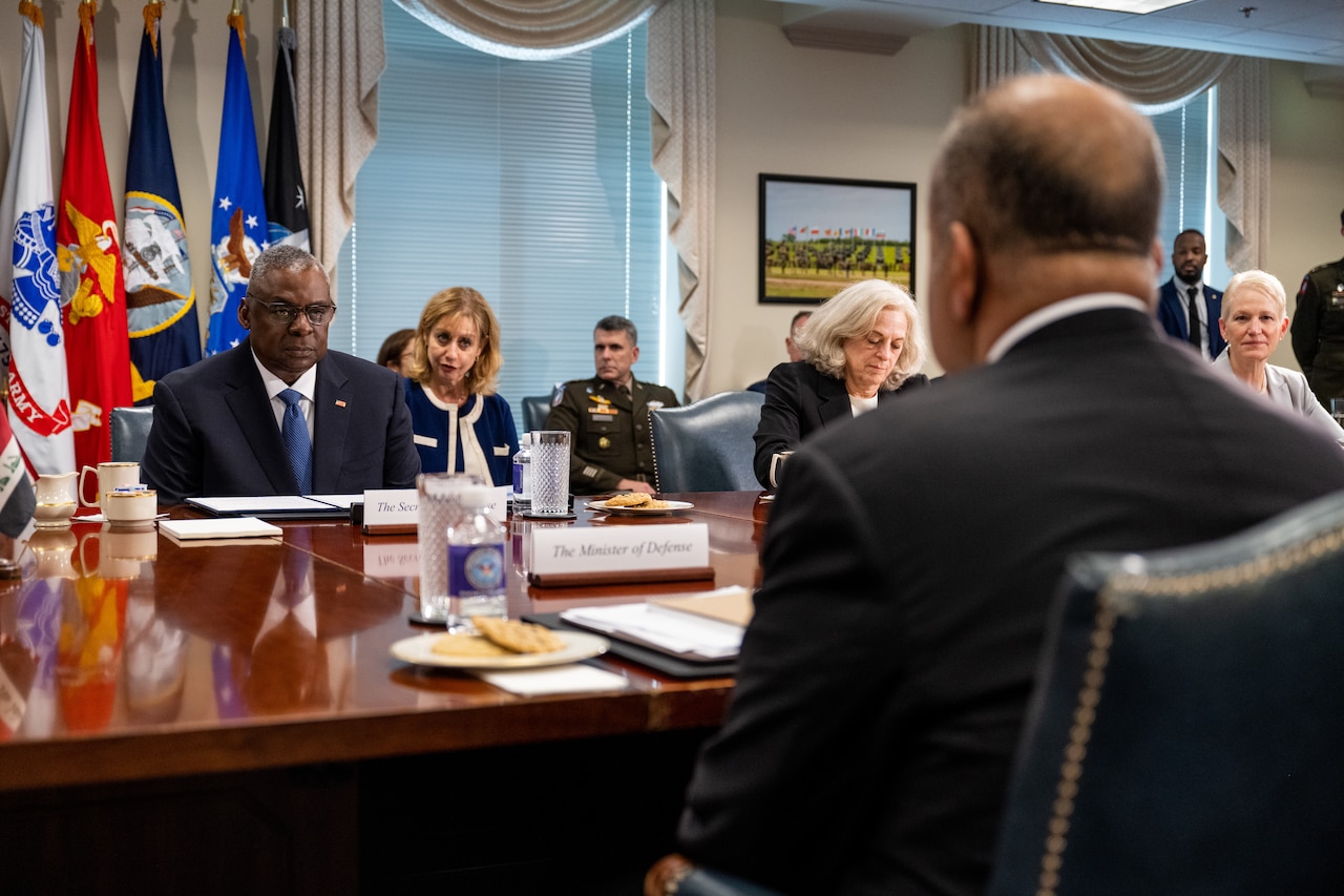 People sit around a conference table.