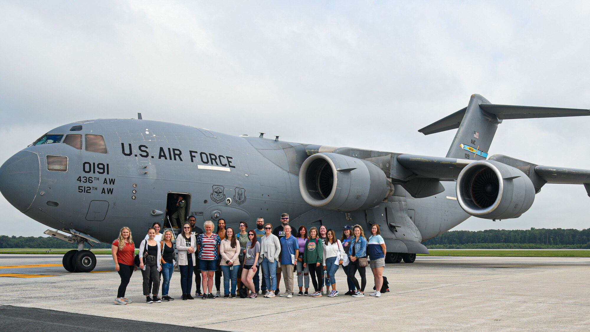 Spouses group photo in front of aircraft