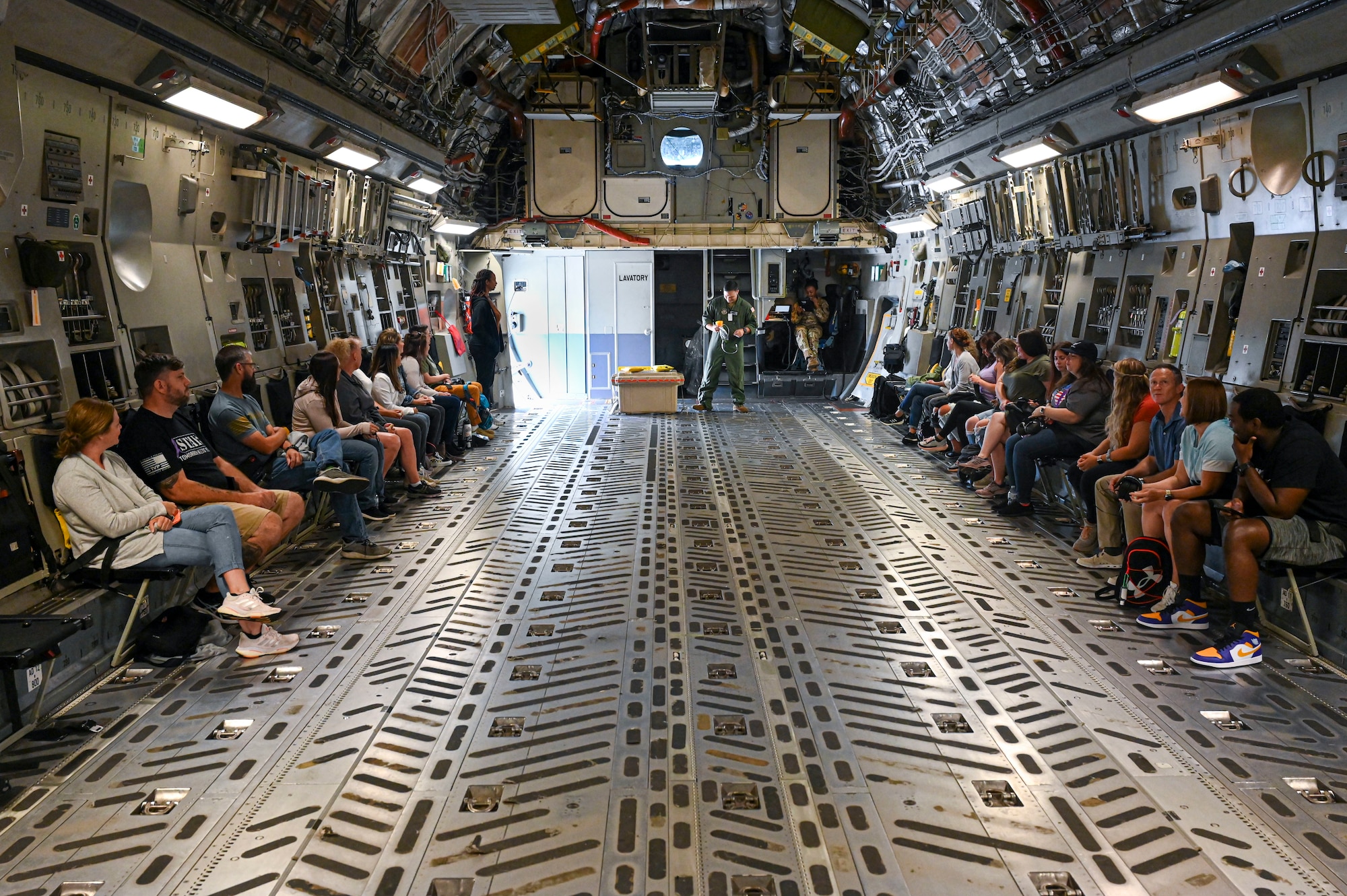 Spouses sit in cargo bay of aircraft