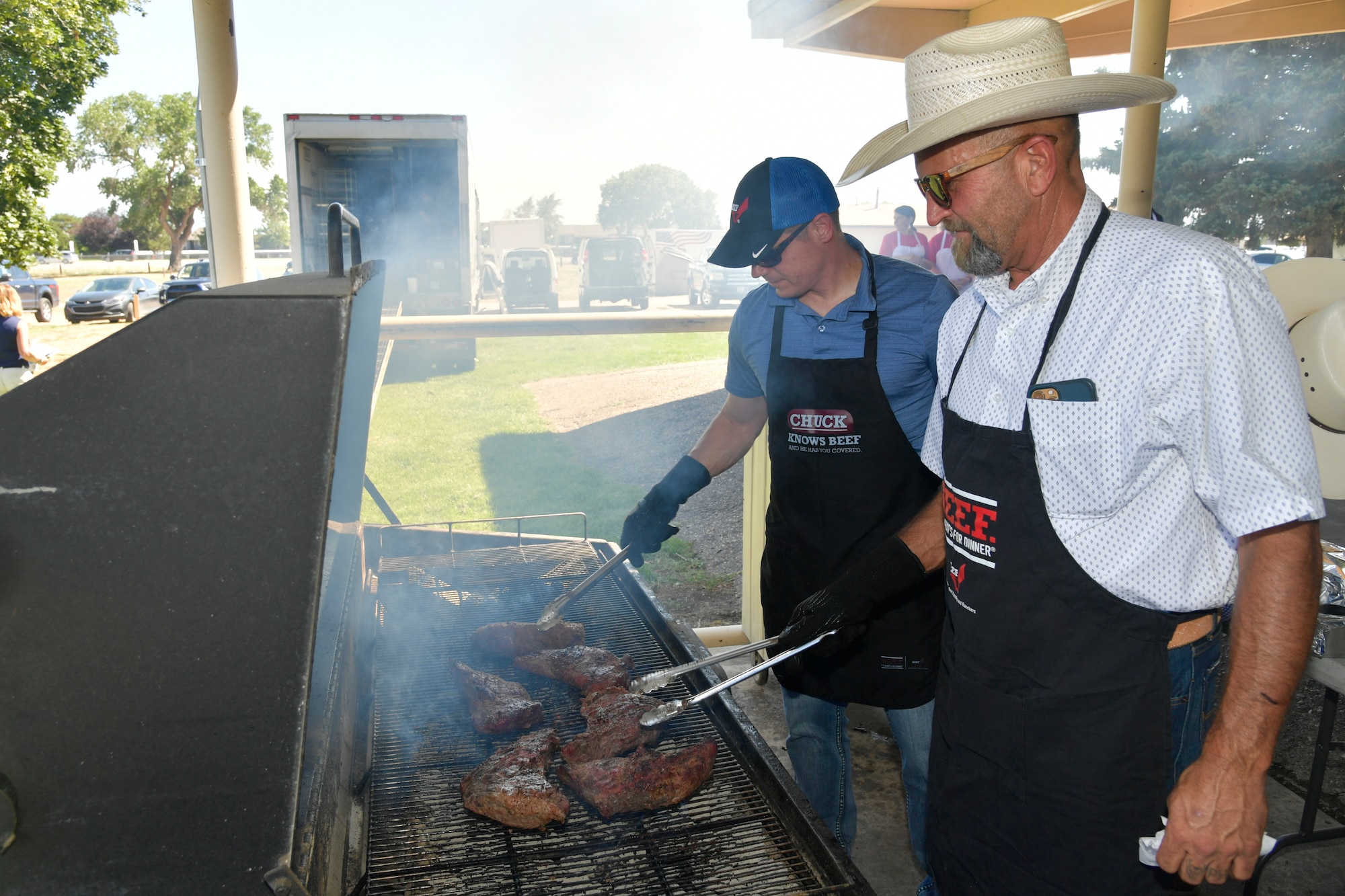 Two volunteers work the grill.