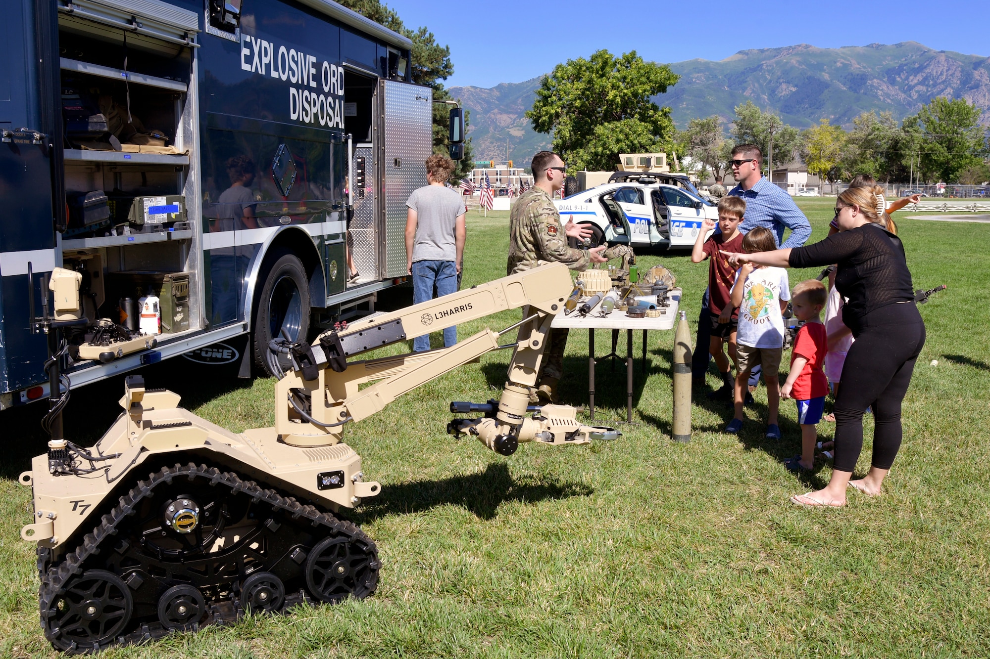 A military family visits the Explosive Ordnance Disposal equipment display.