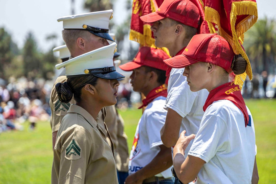 Marines stand face to face with students.
