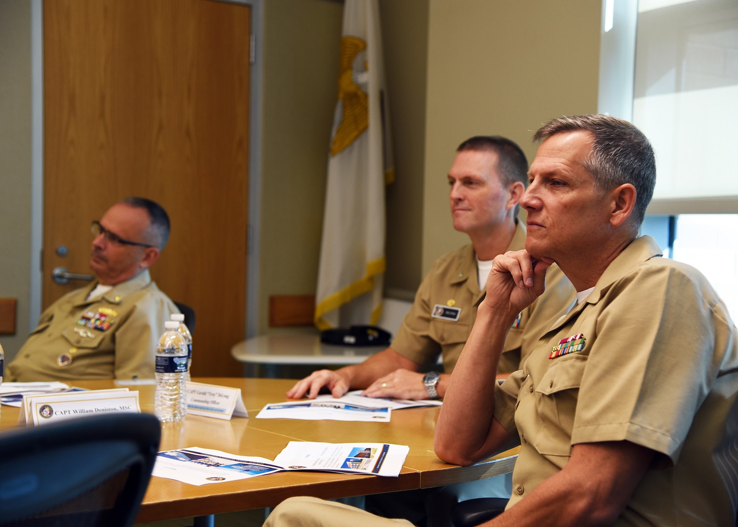 JOINT BASE SAN ANTONIO-FORT SAM HOUSTON – (Aug. 3, 2023) – Capt. William Deniston (right), commander, Naval Medical Research Command (NMRC), joined by Capt. Gerald DeLong, commanding officer, Naval Medical Research Unit (NAMRU) San Antonio, and Capt. Robert Hawkins (left), director, J3/5/7, Defense Health Agency (DHA) and director, U.S. Navy Nurse Corps, attended a command briefing on NAMRU San Antonio’s core capabilities at the Battlefield Health and Trauma Research Institute.  NAMRU San Antonio’s mission is to conduct gap driven combat casualty care, craniofacial, and directed energy research to improve survival, operational readiness, and safety of Department of Defense (DoD) personnel engaged in routine and expeditionary operations. It is one of the leading research and development laboratories for the U.S. Navy under the DoD and is one of eight subordinate research commands in the global network of laboratories operating under NMRC in Silver Spring, Md. (U.S. Navy photo by Burrell Parmer, NAMRU San Antonio Public Affairs/Released)
