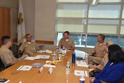 JOINT BASE SAN ANTONIO-FORT SAM HOUSTON – (Aug. 3, 2023) – Capt. Gerald DeLong (center), commanding officer, Naval Medical Research Unit (NAMRU) San Antonio, speaks with Capt. Robert Hawkins, director, J3/5/7, Defense Health Agency (DHA) and director, U.S. Navy Nurse Corps, along with Capt. William Deniston, commander, Naval Medical Research Command (NMRC), during their visit and tour of NAMRU San Antonio facilities at the Battlefield Health and Trauma Research Institute. NAMRU San Antonio’s mission is to conduct gap driven combat casualty care, craniofacial, and directed energy research to improve survival, operational readiness, and safety of Department of Defense (DoD) personnel engaged in routine and expeditionary operations. It is one of the leading research and development laboratories for the U.S. Navy under the DoD and is one of eight subordinate research commands in the global network of laboratories operating under NMRC in Silver Spring, Md. (U.S. Navy photo by Burrell Parmer, NAMRU San Antonio Public Affairs/Released)