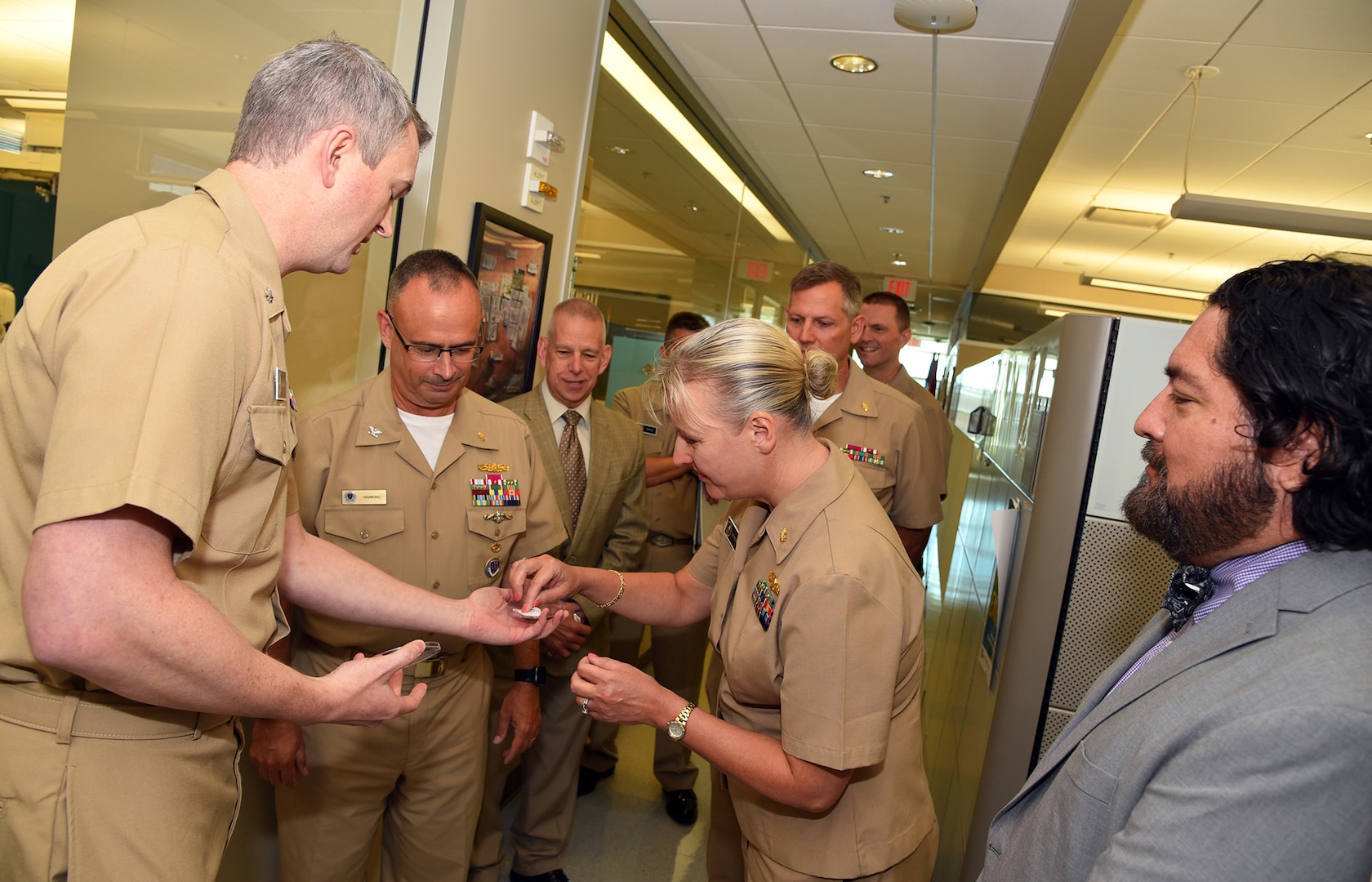 JOINT BASE SAN ANTONIO-FORT SAM HOUSTON – (Aug. 3, 2023) – Cmdr. Drew Havard (left), deputy director, Craniofacial Health and Restorative Medicine (CHRM), Naval Medical Research Unit (NAMRU) San Antonio, joined by Dr. Luis Martinez (right), a research microbiologist assigned to the NAMRU San Antonio’s Biomaterials Department, briefs research on Electrospun Alveolar Ridge Grafts to Capt. Robert Hawkins, director, J3/5/7, Defense Health Agency (DHA) and director, U.S. Navy Nurse Corps, along with incoming NAMRU San Antonio Commanding Officer Capt. Jennifer Buechel during a tour of NAMRU San Antonio facilities at the Battlefield Health and Trauma Research Institute. NAMRU San Antonio’s mission is to conduct gap driven combat casualty care, craniofacial, and directed energy research to improve survival, operational readiness, and safety of Department of Defense (DoD) personnel engaged in routine and expeditionary operations. It is one of the leading research and development laboratories for the U.S. Navy under the DoD and is one of eight subordinate research commands in the global network of laboratories operating under Naval Medical Research Command in Silver Spring, Md. (U.S. Navy photo by Burrell Parmer, NAMRU San Antonio Public Affairs/Released)