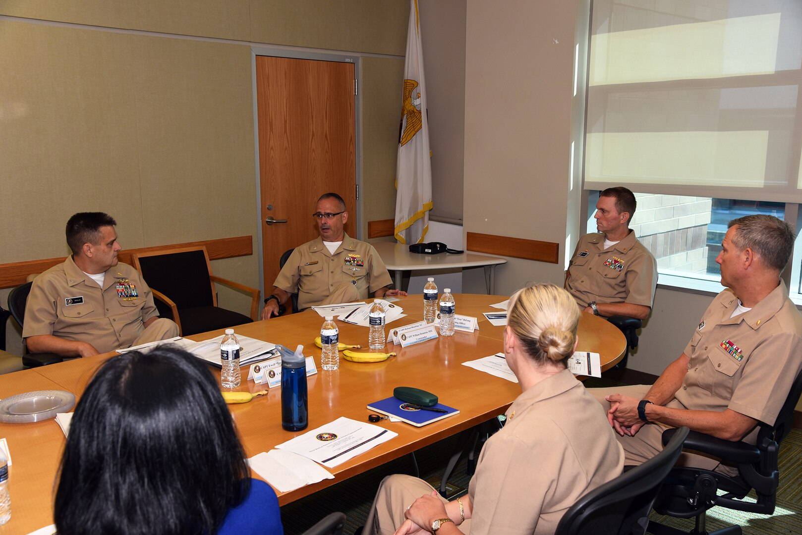 JOINT BASE SAN ANTONIO-FORT SAM HOUSTON – (Aug. 3, 2023) – Capt. Robert Hawkins (center-left), director, J3/5/7, Defense Health Agency (DHA) and director, U.S. Navy Nurse Corps, speaks on the culture of Navy Medicine and Navy Medical Research during a visit to Naval Medical Research Unit (NAMRU) San Antonio.  He, along with Capt. William Deniston, commander, Naval Medical Research Command (NMRC), received a tour of NAMRU San Antonio facilities at the Battlefield Health and Trauma Research Institute and Tri-Service Research Laboratory.  NAMRU San Antonio’s mission is to conduct gap driven combat casualty care, craniofacial, and directed energy research to improve survival, operational readiness, and safety of Department of Defense (DoD) personnel engaged in routine and expeditionary operations. It is one of the leading research and development laboratories for the U.S. Navy under the DoD and is one of eight subordinate research commands in the global network of laboratories operating under NMRC in Silver Spring, Md. (U.S. Navy photo by Burrell Parmer, NAMRU San Antonio Public Affairs/Released)