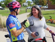 Gold Star Mother and Survivor Outreach Services Coordinator Jean Harris talks to Illinois Air National Guard Senior Master Sgt. David Schreffler as the Gold Star 500 as the riders arrive at the Great Lakes Community Center, part of the Naval Station Great Lakes near North Chicago, Illinois, on Sept. 24, 2022.