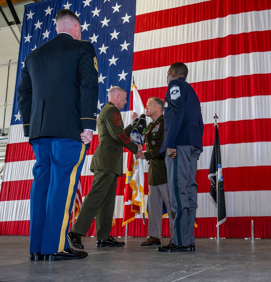 U.S. Marine Corps Master Gunnery Sgt. Scott Stalker outgoing command senior enlisted leader passes  the U.S. Space Command colors to U.S. Army Gen. James Dickinson, USSPACECOM commander, Aug. 7, 2023, during the command’s change of responsibility at Peterson Space Force Base, Colo.