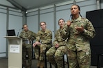 2nd Lt. Charnelle Pinson, a forward support medevac section leader with the Wisconsin Army National Guard’s 1st Battalion, 168th Aviation Regiment, discusses her military career as Maj. Sarah Latza, Capt. Meredith Porter and Capt. Anna Leadens look on during a panel discussion July 26, 2023, in Oshkosh, Wis., as part of the Experimental Aircraft Association’s WomenVenture.