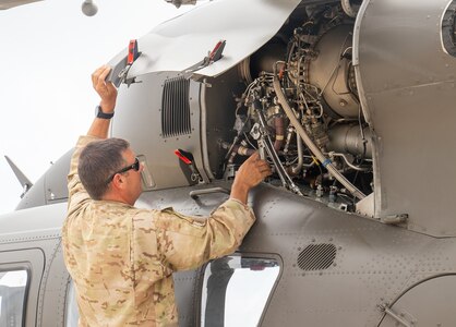 Illinois Army National Guard Chief Warrant Officer 4 Josh Perrott completes the safety check before his final flight as an Army aviator Aug. 3 at the Army Aviation Support Facility in Decatur, Illinois. Perrott, who retires Nov. 1, has served 31 years in the Illinois Army National Guard.