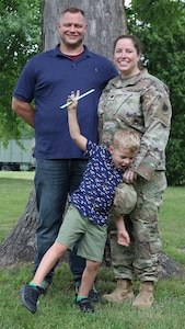 Five-year-old George Steven poses with his parents, George and Jaime Marlock, during Lt. Col. Jaime Marlock's promotion ceremony.