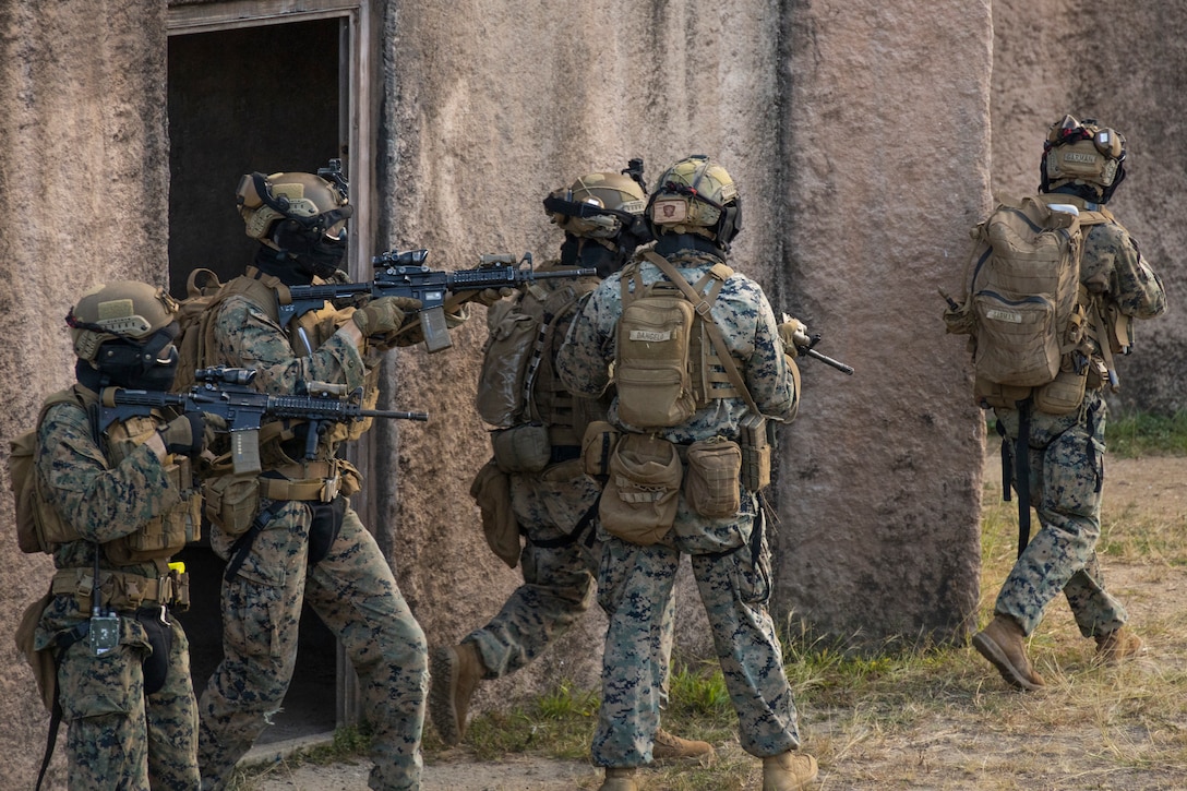 U.S. Marines with Advanced Infantry Training Battalion, School of Infantry-West, Hawaii Detachment, prepare to breach a building during urban operations training, Marine Corps Training Area Bellows, July 11, 2023. The training was conducted as part of the Advanced Infantry Marine Course. AIMC is designed to enhance and test Marines’ skills with a focus on reinforcing proper patrols and operational procedures. (U.S. Marine Corps photo by Cpl. Chandler Stacy)