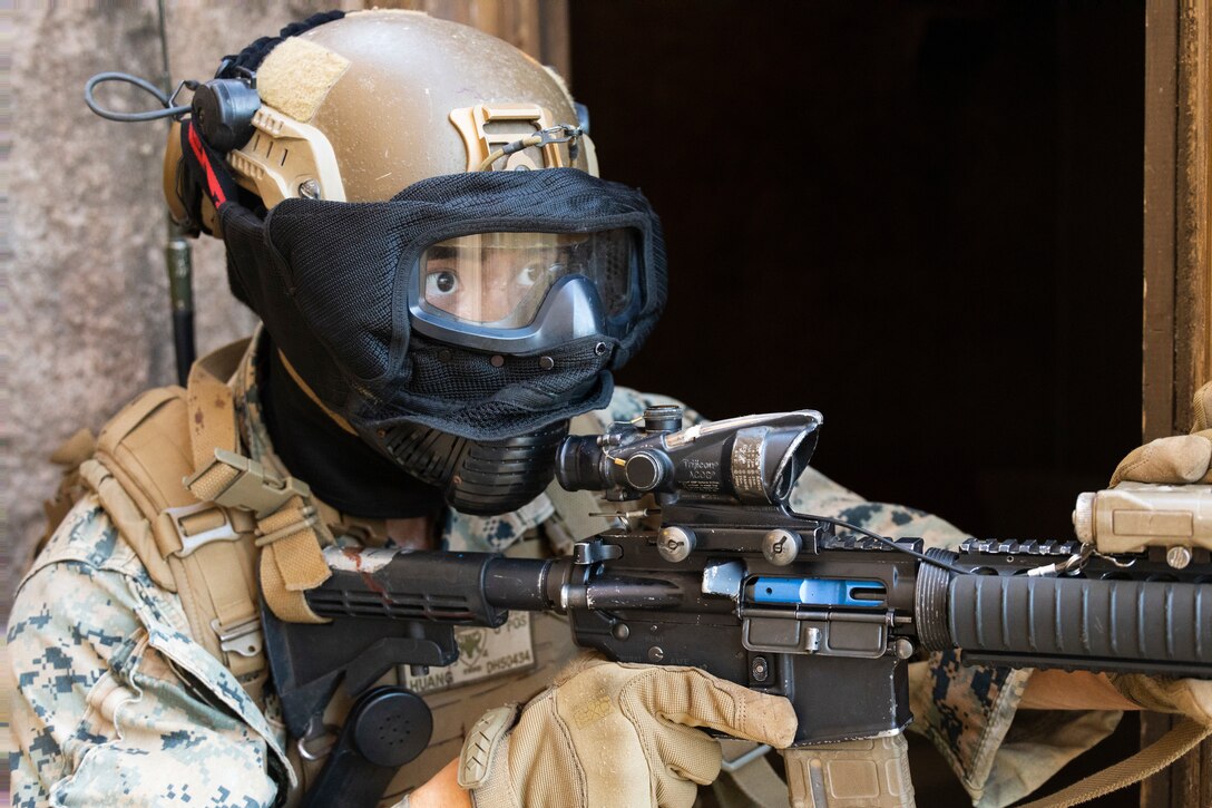 U.S. Marine Corps Cpl. Daniel Huang, a student in the Advanced Infantry Marine Course, engages simulated enemy combatants during urban operations training, Marine Corps Training Area Bellows, July 11, 2023. The training was conducted as part of the Advanced Infantry Marine Course. AIMC is designed to enhance and test Marines’ skills with a focus on reinforcing proper patrols and operational procedures. (U.S. Marine Corps photo by Cpl. Chandler Stacy)