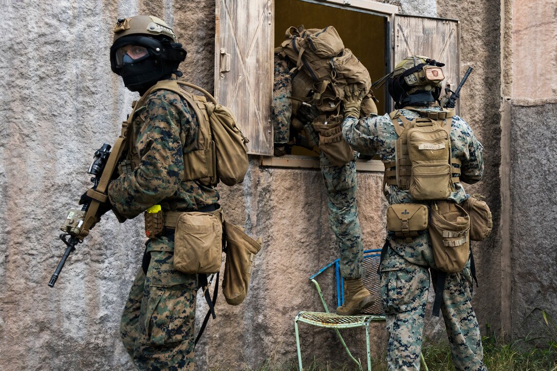 U.S. Marines with Advanced Infantry Training Battalion, School of Infantry-West, Hawaii Detachment, enter a building during urban operations training, Marine Corps Training Area Bellows, July 11, 2023. The training was conducted as part of the Advanced Infantry Marine Course. AIMC is designed to enhance and test Marines’ skills with a focus on reinforcing proper patrols and operational procedures. (U.S. Marine Corps photo by Cpl. Chandler Stacy)