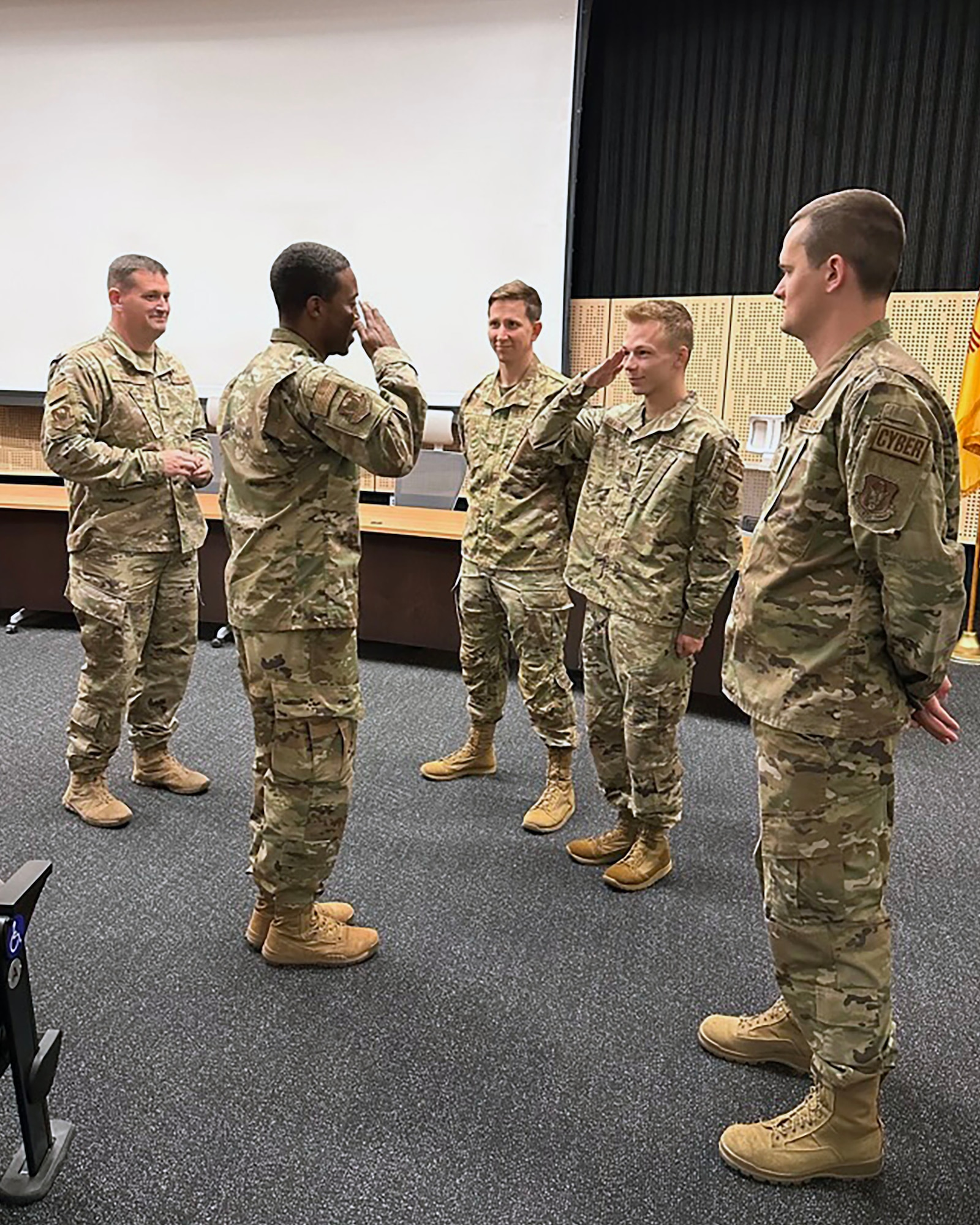 Staff Sgt. Zachery Amundson, 51st Network Operations Squadron, salutes Col. Silas Darden, 960th Cyberspace Wing commander, after receiving a coin at Central New Mexico Community College in Albuquerque, New Mexico on July 20, 2023. (Courtesy photo)