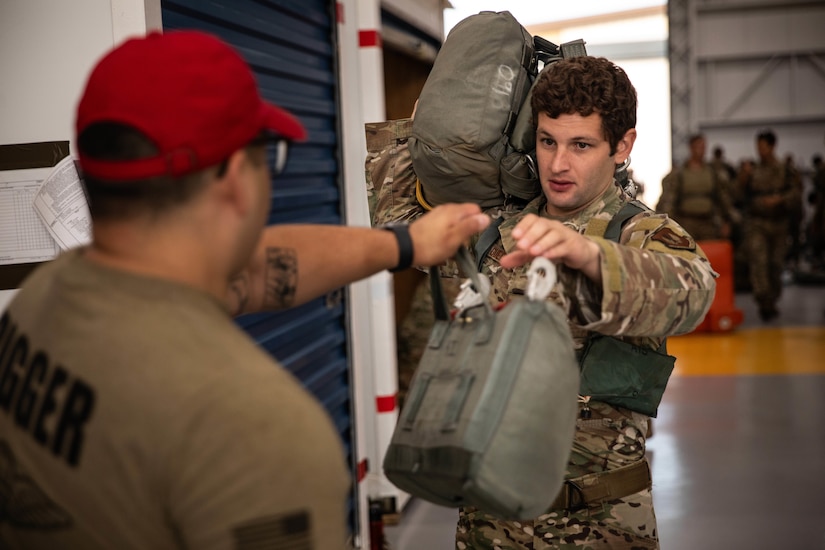 An airman receivers his parachutes.