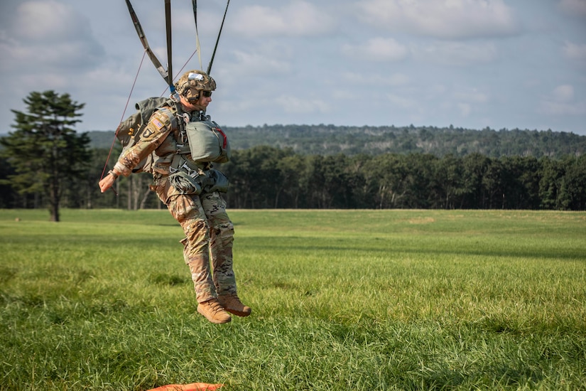 A paratrooper prepares to hit the ground.