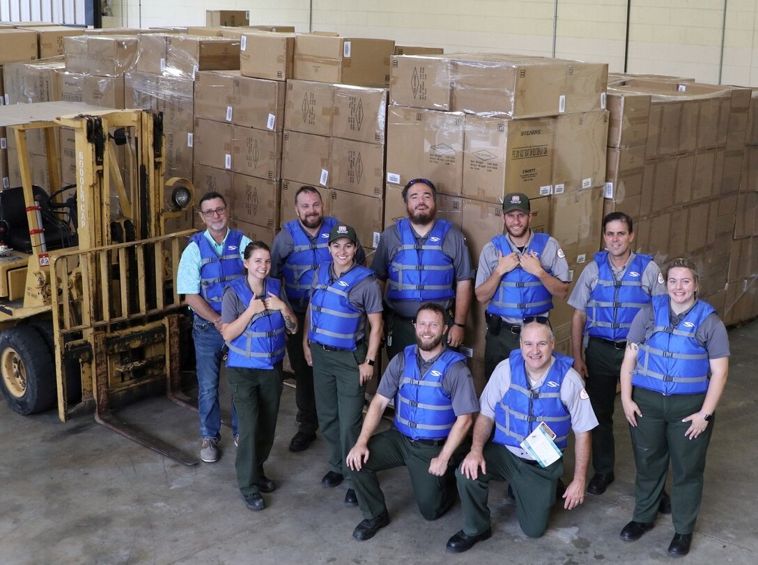 10 staff members from Allatoona Lake pose wearing blue life jackets.