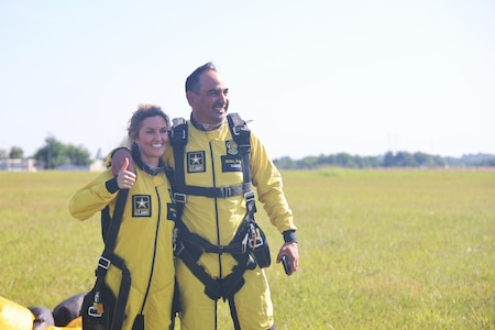 One Golden Knights member stands next to a tandem jumper.