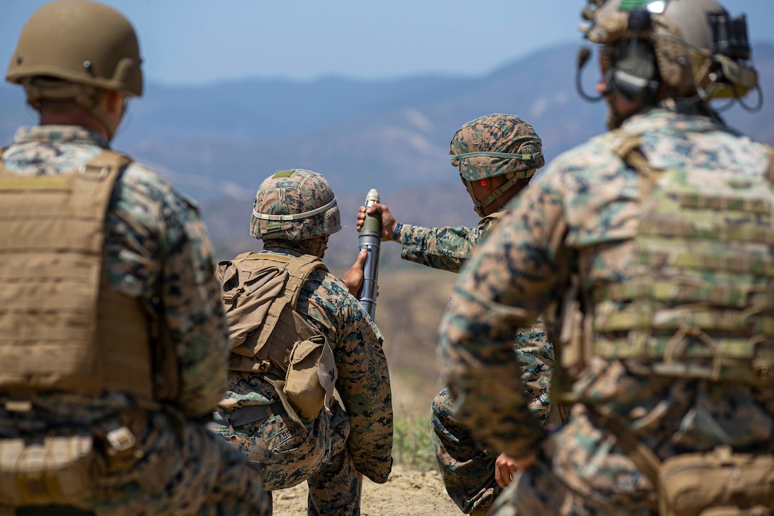 U.S. Marines participating in the Infantry Unit Leadership Course, prepare to half load an M224 60 mm mortar during live-fire training on Mortar Position 6 on Marine Corps Base Camp Pendleton, California, June 30, 2020. Marines with IULC utilized various weapons systems during the training to increase proficiency and readiness. The Marines participating in the course will leave as 0369 infantry unit leaders. (U.S. Marine Corps photo by Lance Cpl. Andrew Cortez)