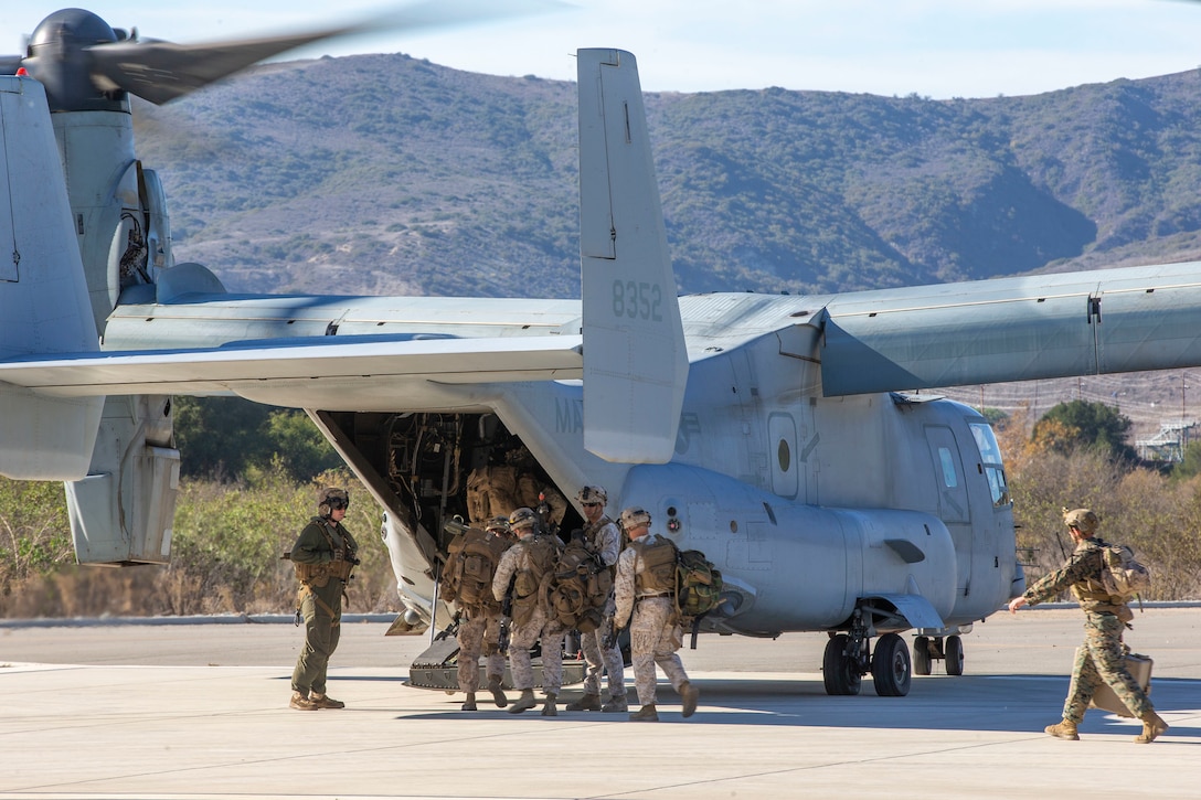 U.S. Marines with the Infantry Small Unit Leaders Course 1-22, Advanced Infantry Training Battalion, School of Infantry - West, board an MV-22B Osprey as part of a training exercise on Marine Corps Base Camp Pendleton, California, Nov 16, 2021. The students conducted an aerial assault which took them from SOI-West on Camp Pendleton to Yuma, Arizona. ISULC is designed to teach noncommisioned officers advanced infantry skills and equip them to assume more leadership responsibility within an infantry battalion. (U.S Marine Corps photo by Cpl. Drake Nickels)