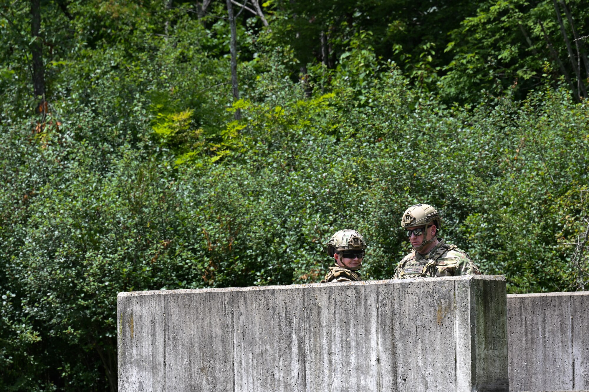 Tech. Sgt. Cara Shaw, an Integrated Defense Leadership Course cadre member assigned to the 307th Security Forces Squadron, Barksdale Air Force Base, Louisiana, and Senior Master Sgt. Daniel Chase, IDLC chief assigned to the 310th SFS, Schriever Space Force Base, Colorado, prepare to detonate a grenade on July 21, 2023, at Camp James A. Garfield Joint Military Training Center, Ohio.