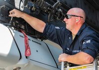 U.S. Air Force Staff Sgt. Lewis Hafner, 5th Aircraft Maintenance Squadron weapons team chief, secures an inert precision guided munition onto the wing pylon of a B-52H Stratofortress at Minot Air Force Base, North Dakota, Aug. 3, 2023. Hafner provided directions to his team throughout the weapons loading process. (U.S. Air Force photo by Airman 1st Class Kyle Wilson)