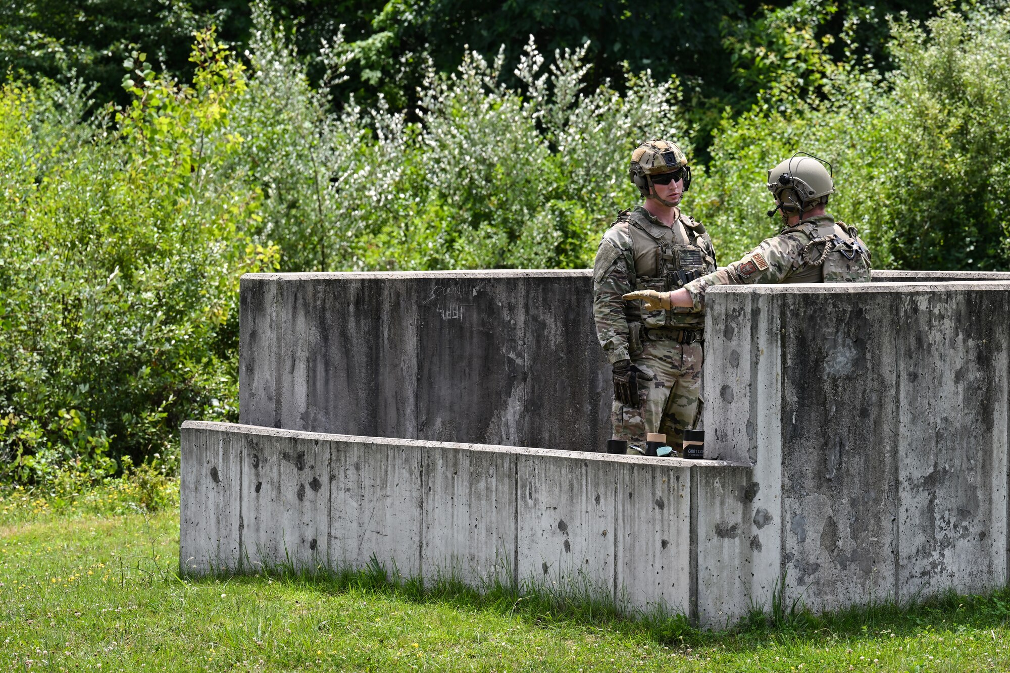 Tech. Sgt. Johnathan Kling, an Integrated Defense Leadership Course cadre member assigned to the 307th Security Forces Squadron, Barksdale Air Force Base, Louisiana, instructs Tech. Sgt. Matthew Turner, a Defender assigned to the 145th SFS, North Carolina Air National Guard, prior to detonating a grenade on July 21, 2023, at Camp James A. Garfield Joint Military Training Center, Ohio.